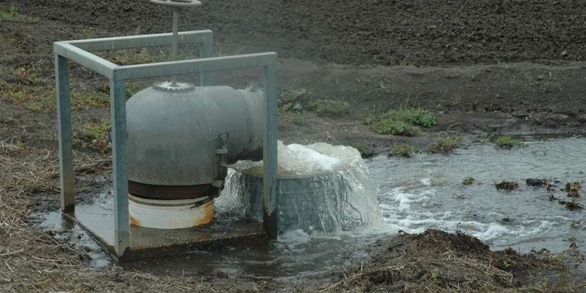 Water from industrial pump flowing into field