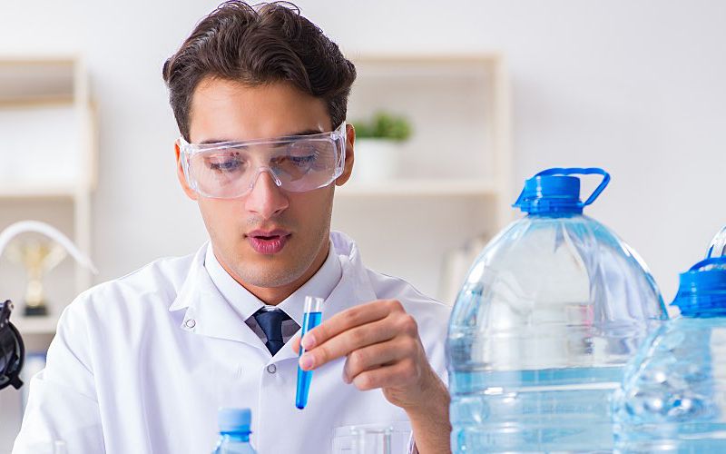 Scientist examining water sample in laboratory